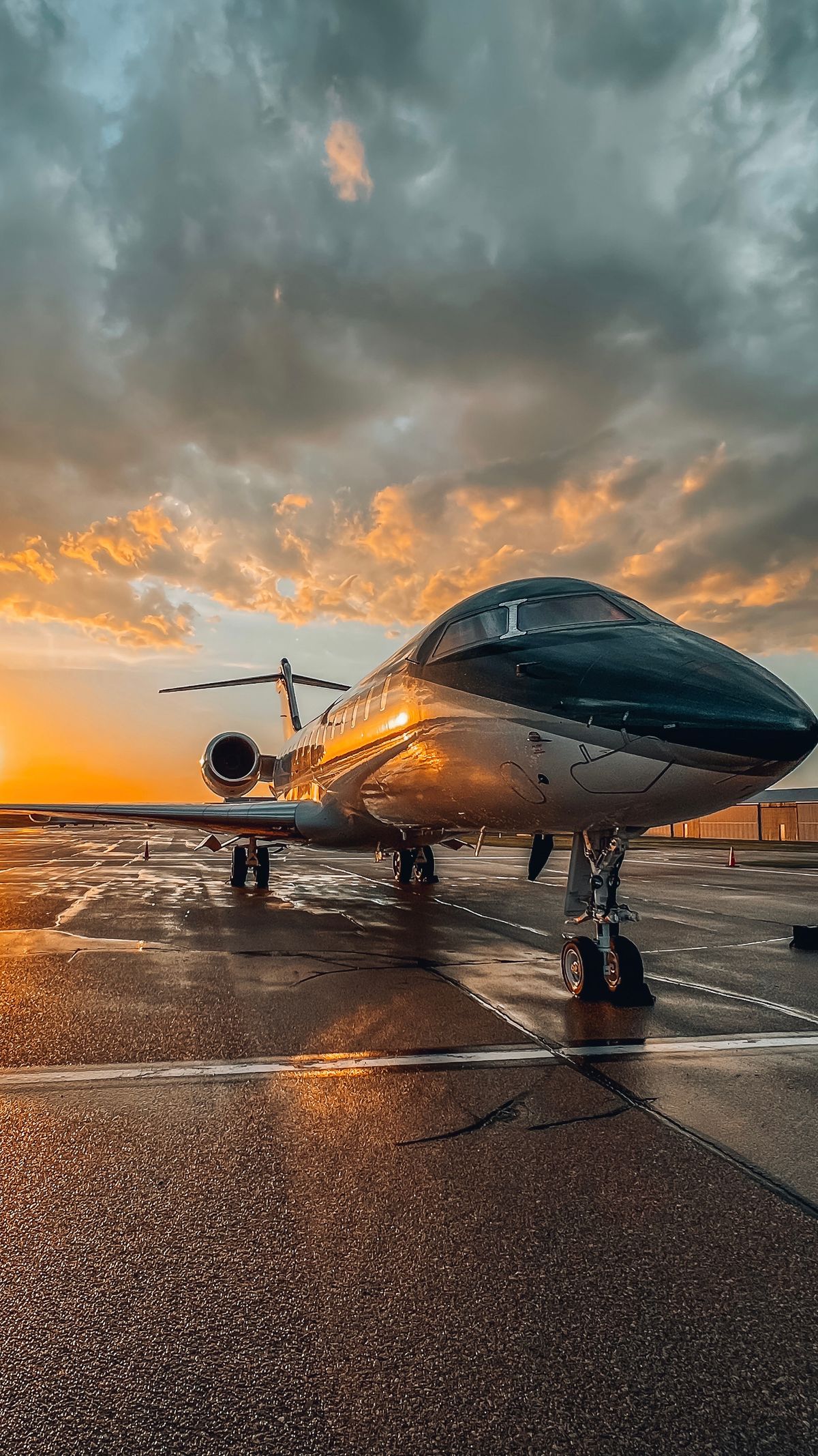 Private jet parked on an airport apron at sunset